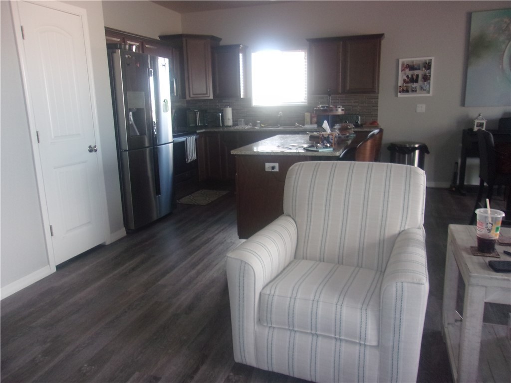 5414 Eagle View Road Kingman, AZ 86409 - Photo 38 of 39 Kitchen with a kitchen island, stainless steel fridge with ice dispenser, dark wood-style floors, and backsplash