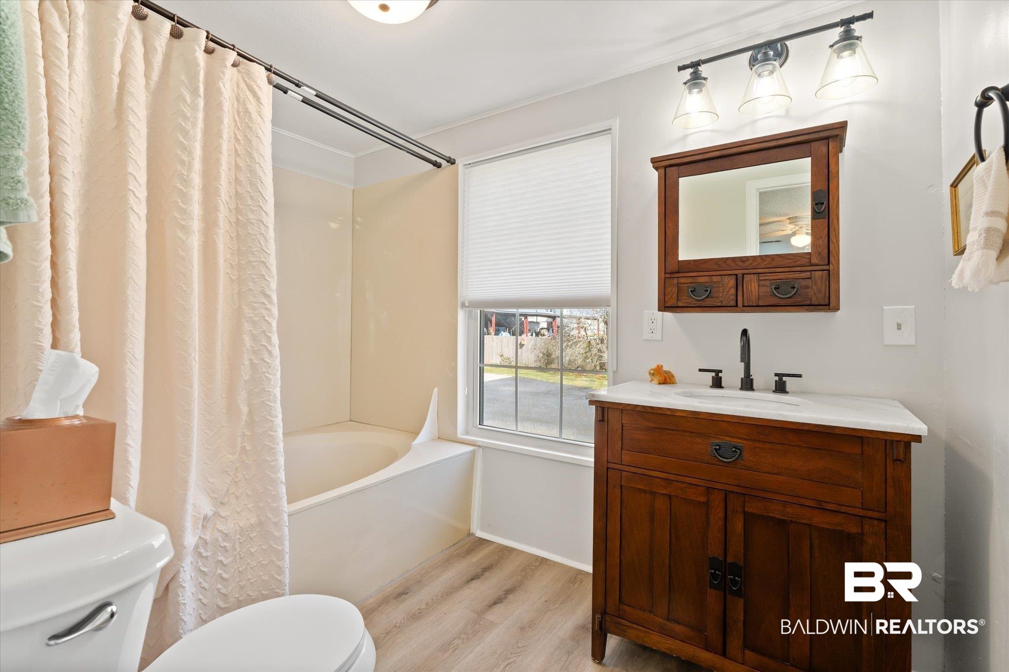 14280 Cat Deakle Road Grand Bay, AL 36541 - Photo 16 of 51 Bathroom with shower / bath combination with curtain, vanity, wood finished floors, and toilet