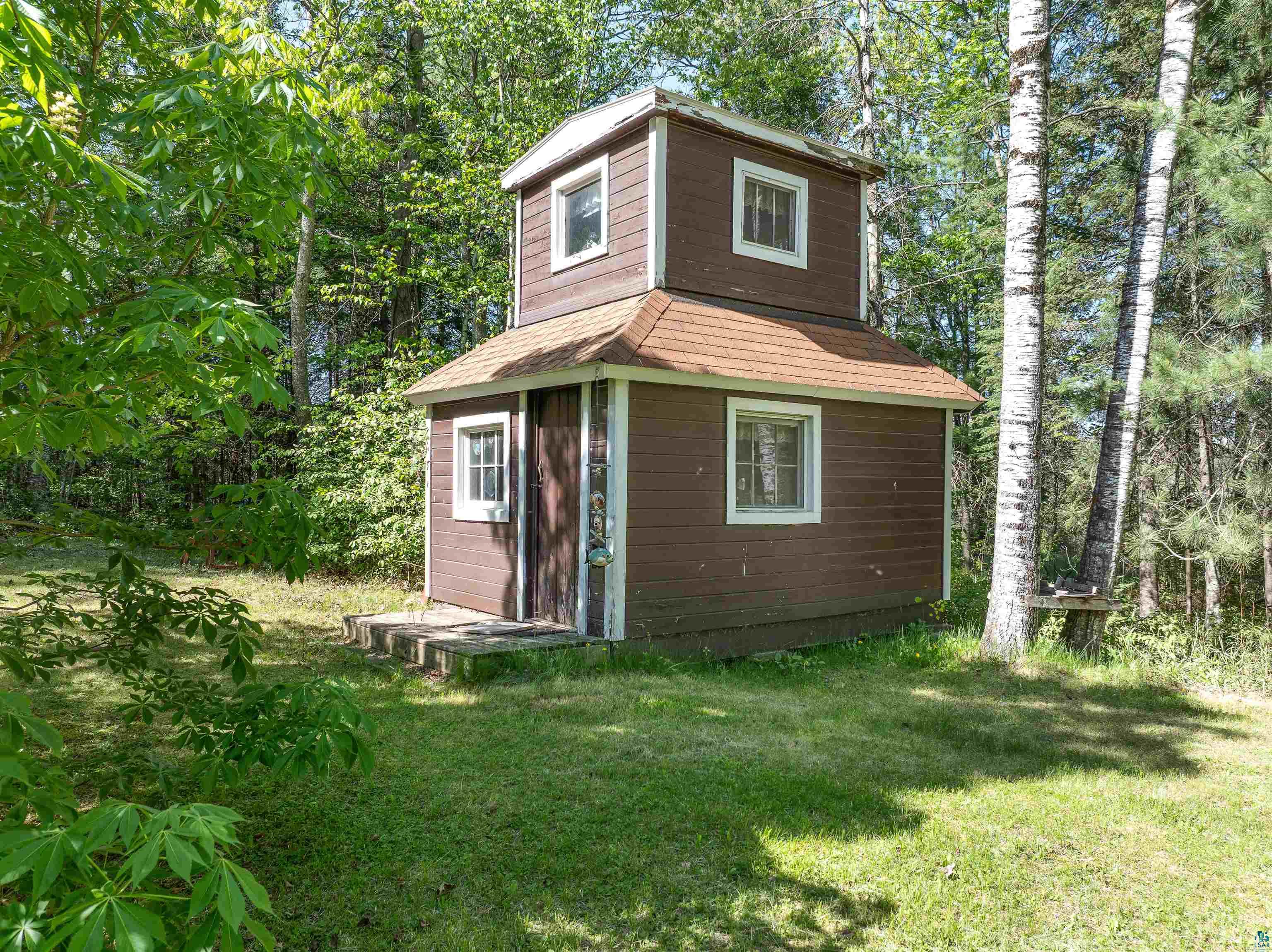 9064 Peppard Road Britt, MN 55710 - Photo 26 of 40 Two-story outbuilding with brown siding and white-framed windows