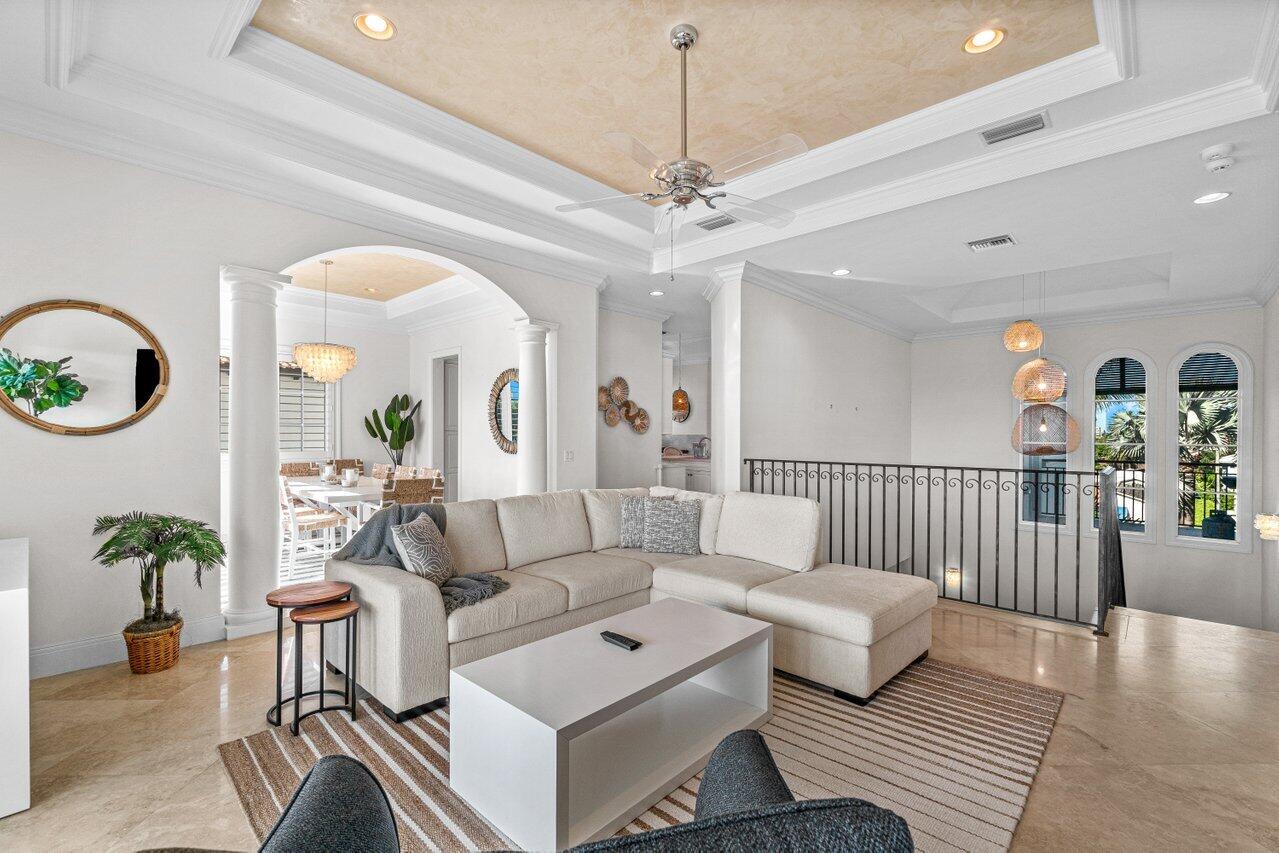 6103 North Ocean Boulevard Ocean Ridge, FL 33435 - Photo 19 of 53 a living room with furniture a chandelier and a rug