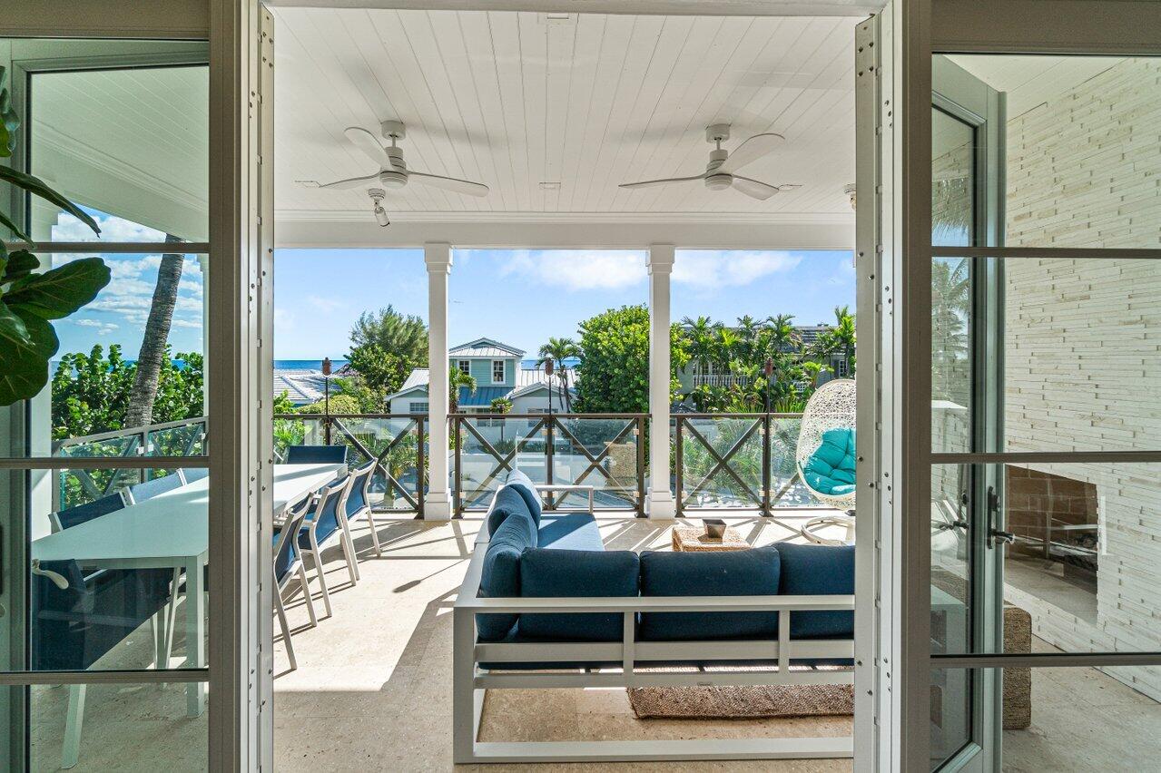 6103 North Ocean Boulevard Ocean Ridge, FL 33435 - Photo 37 of 53 a living room filled with furniture and a floor to ceiling window
