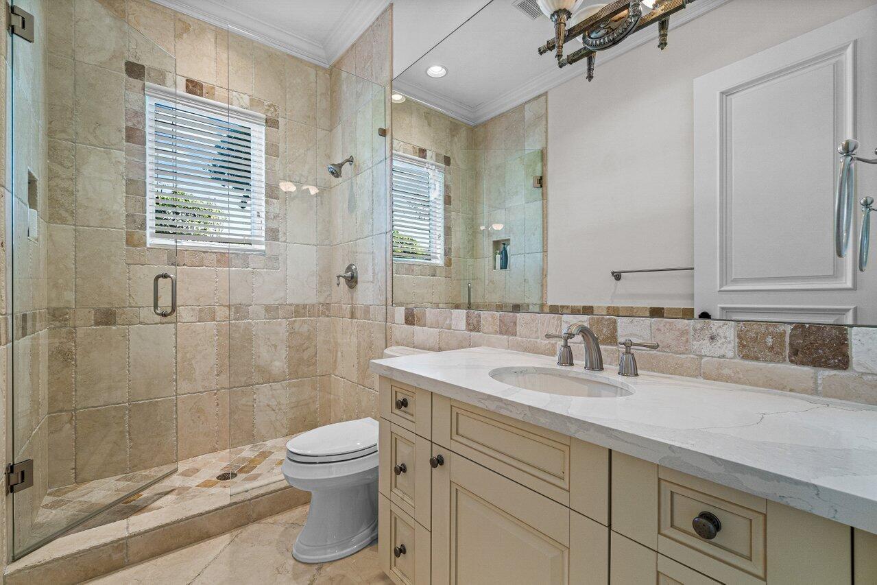 6103 North Ocean Boulevard Ocean Ridge, FL 33435 - Photo 10 of 53 a bathroom with a double vanity sink toilet and shower