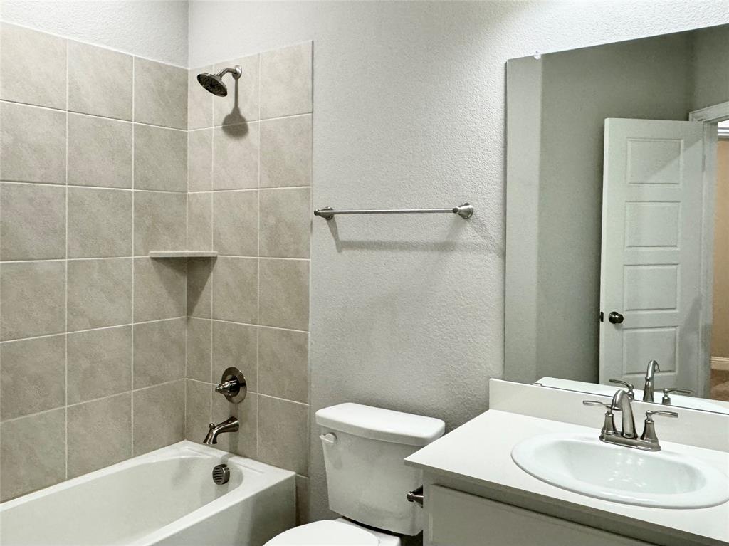 6408 Rienzi Drive Greenville, TX 75402 - Photo 11 of 20 a bathroom with a sink toilet and shower