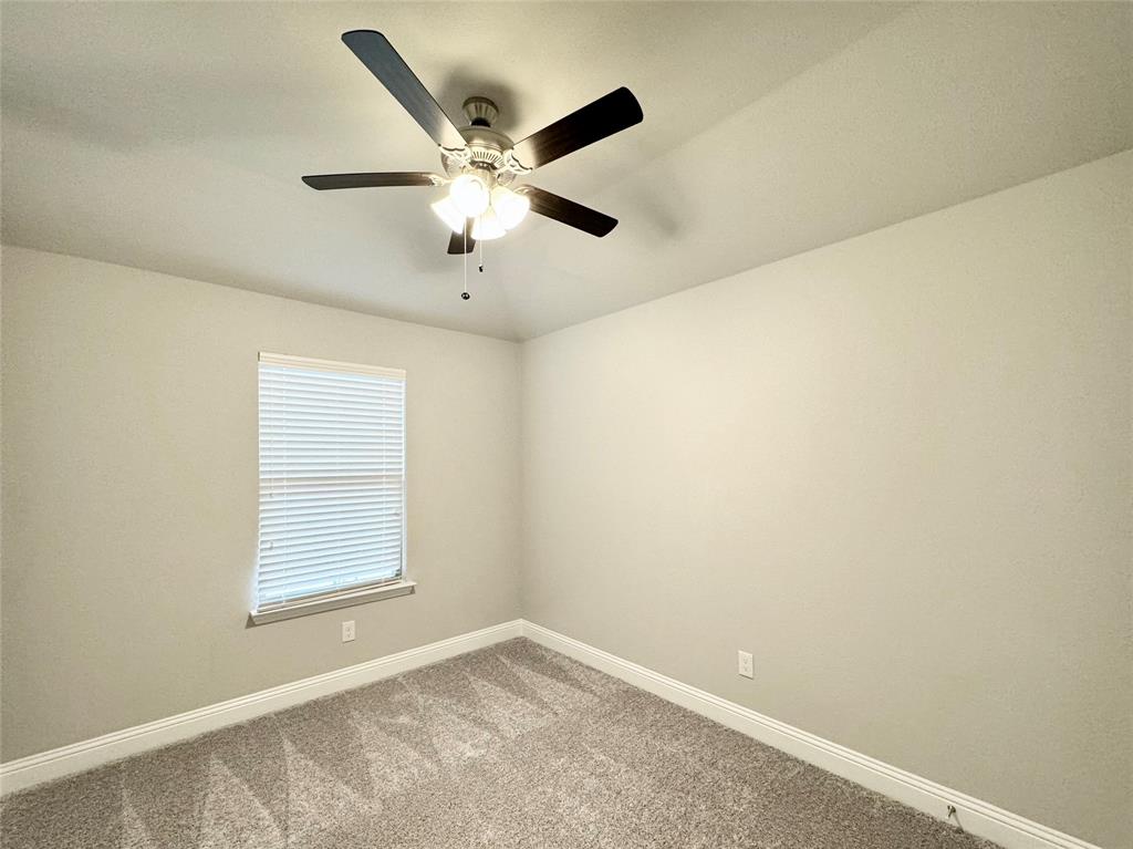 6408 Rienzi Drive Greenville, TX 75402 - Photo 15 of 20 an empty room with windows and fan