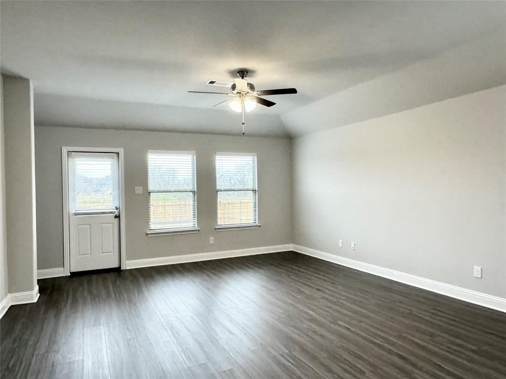 6408 Rienzi Drive Greenville, TX 75402 - Photo 7 of 20 an empty room with wooden floor and windows