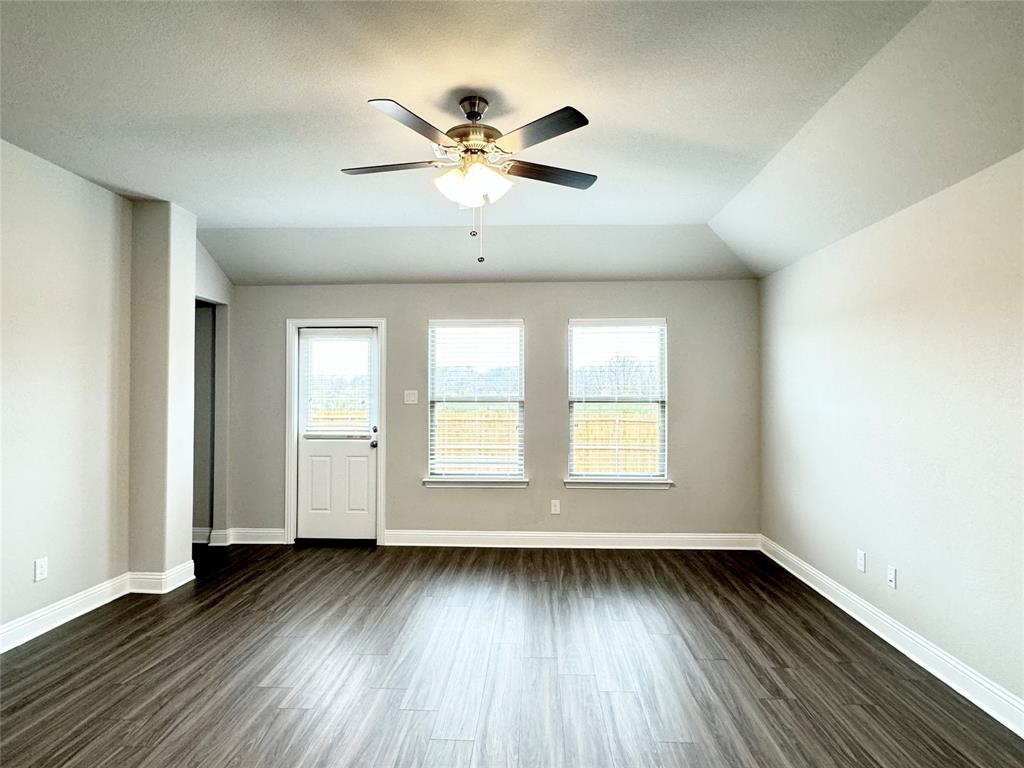 6408 Rienzi Drive Greenville, TX 75402 - Photo 9 of 20 a view of an empty room with wooden floor and a window