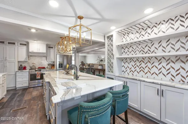 a kitchen with a stove and wooden floor