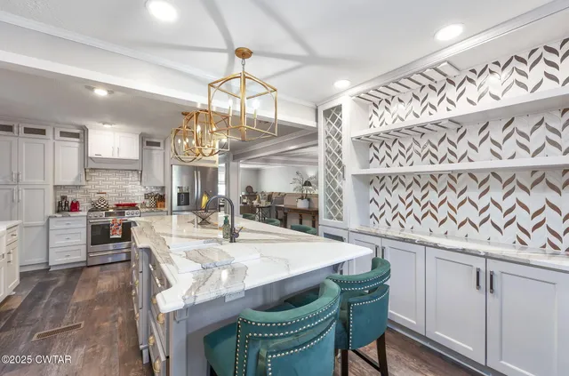 a kitchen with a stove and wooden floor