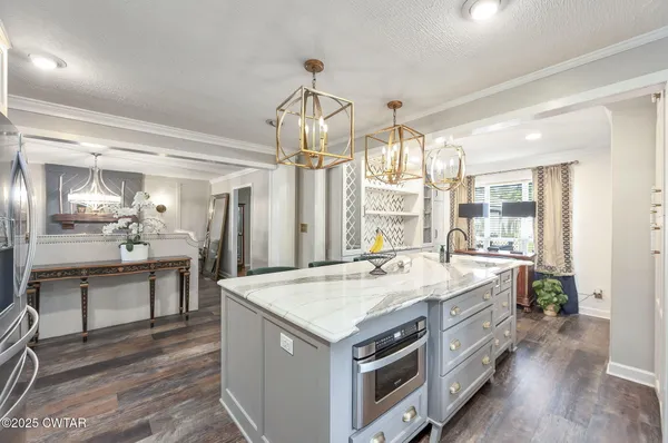 a view of a dining room with furniture a chandelier and wooden floor