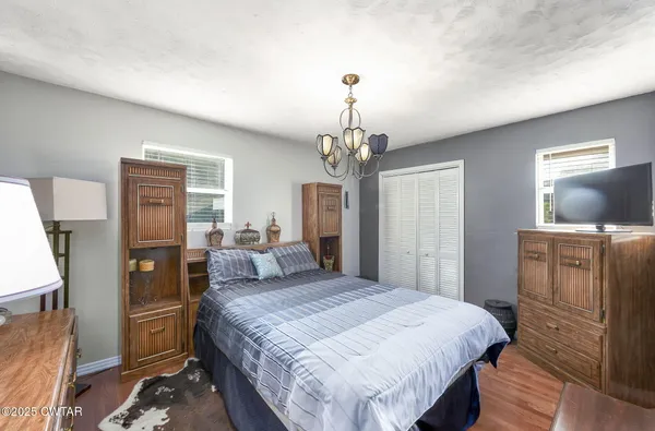 a bedroom with a bed and a dresser