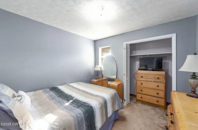 a bathroom with a granite countertop sink a toilet and mirror