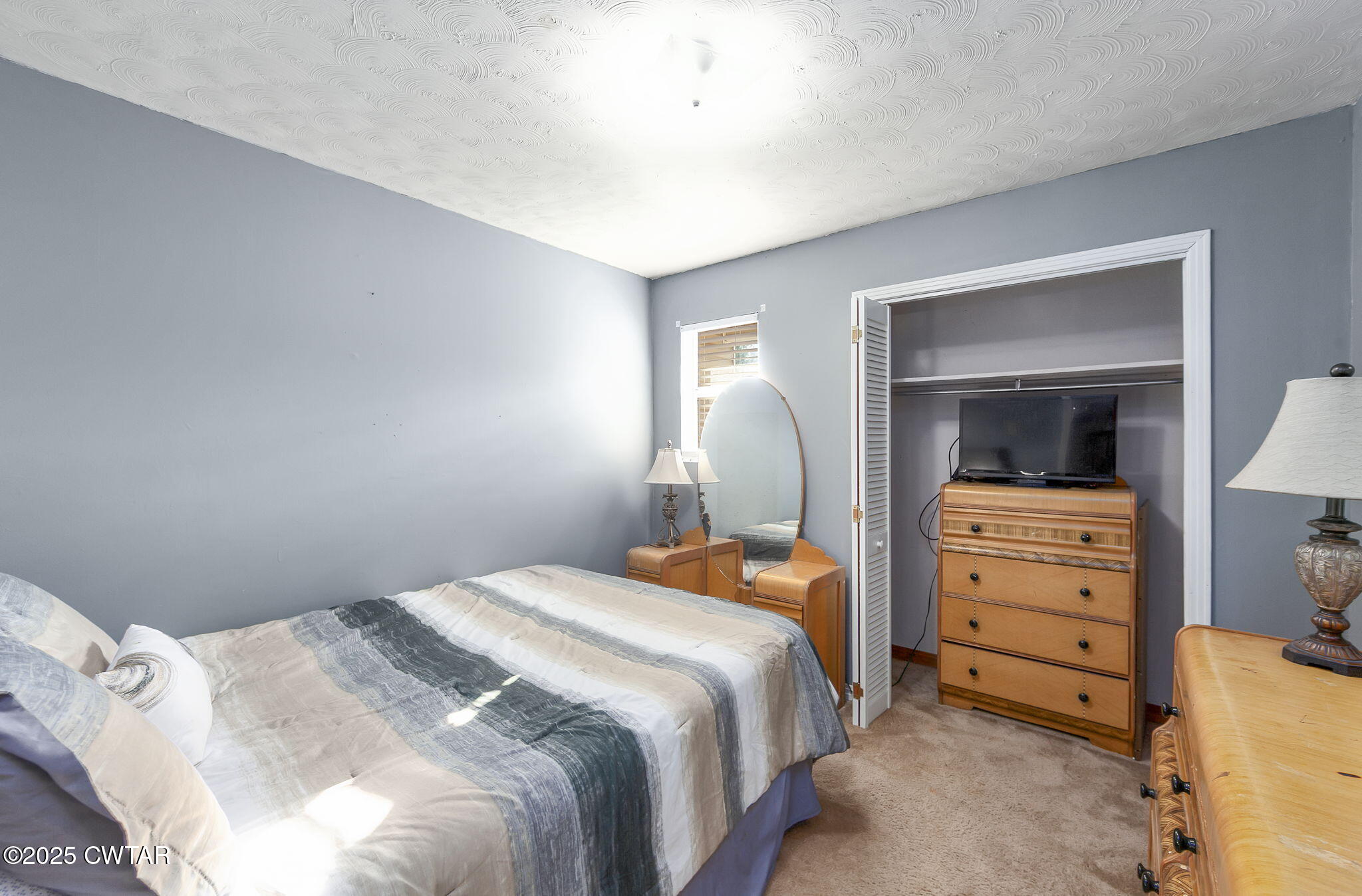 472 Old Denmark Road Jackson, TN 38301 - Photo 24 of 44 a bedroom with a bed and a dresser