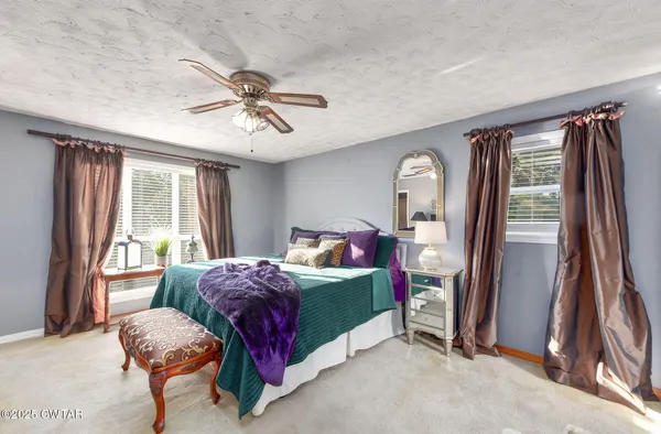 a bedroom with bed and a chandelier
