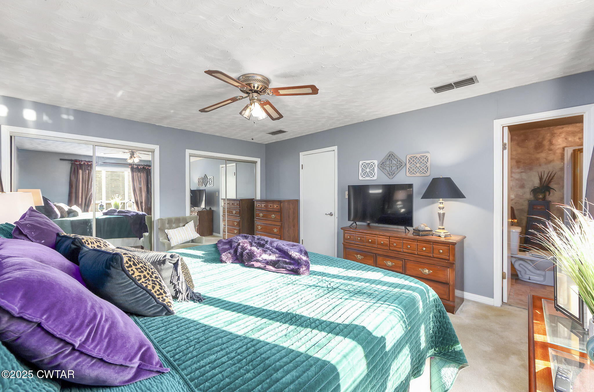 472 Old Denmark Road Jackson, TN 38301 - Photo 27 of 44 a bedroom with bed and a chandelier