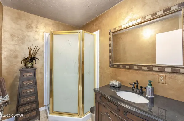 a dining room with furniture a chandelier and wooden floor