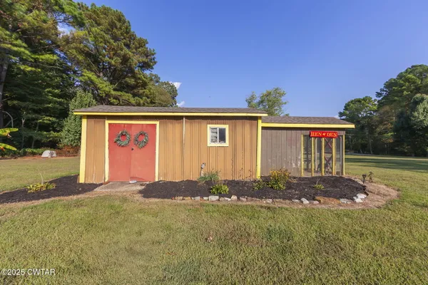 a view of a house with swimming pool and a yard