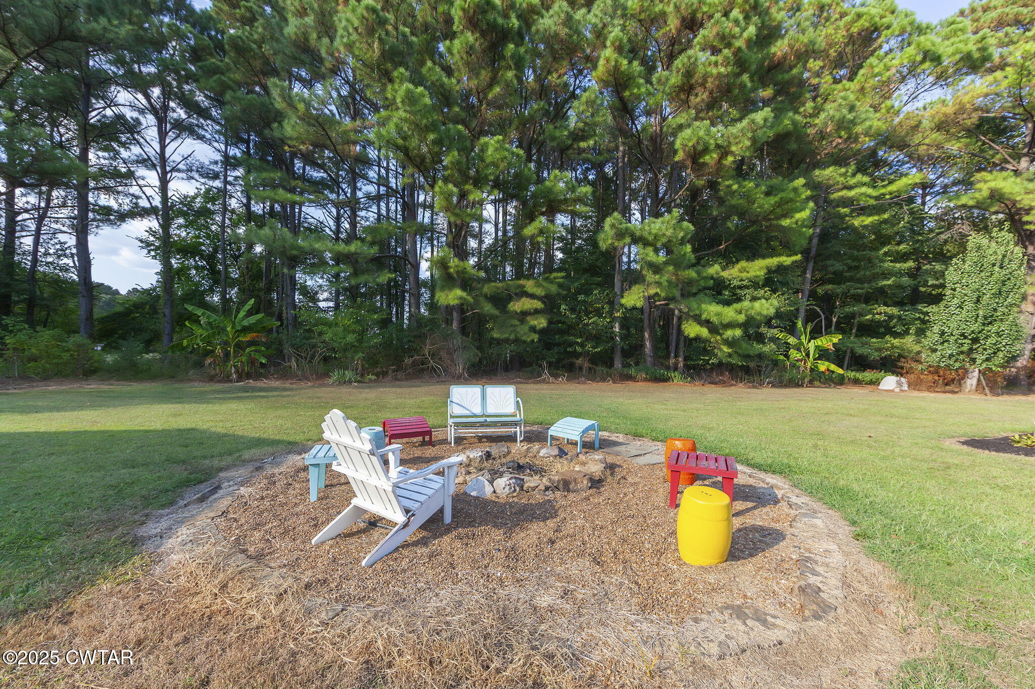 472 Old Denmark Road Jackson, TN 38301 - Photo 35 of 44 a view of a backyard with table and chairs under an umbrella
