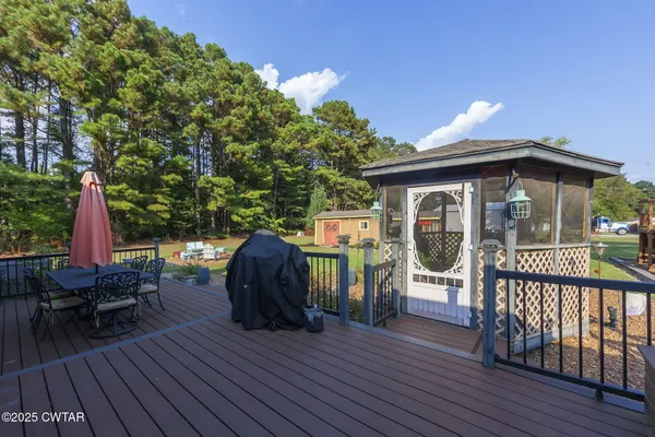 a view of a wooden deck front of house