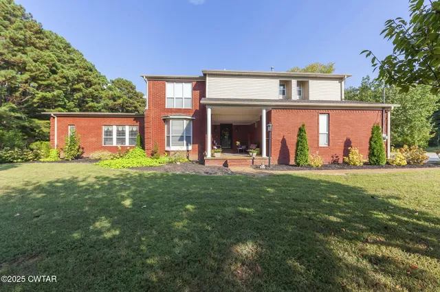 a front view of house with yard and green space
