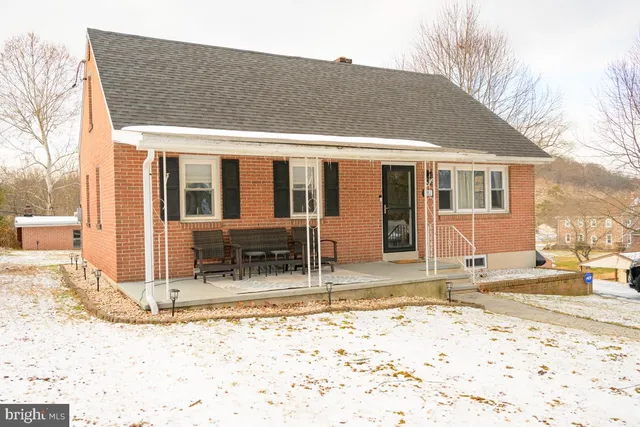 a view of a house with a snow on the road