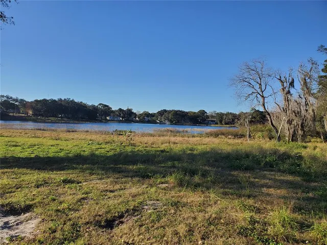 a view of a lake with houses in the background