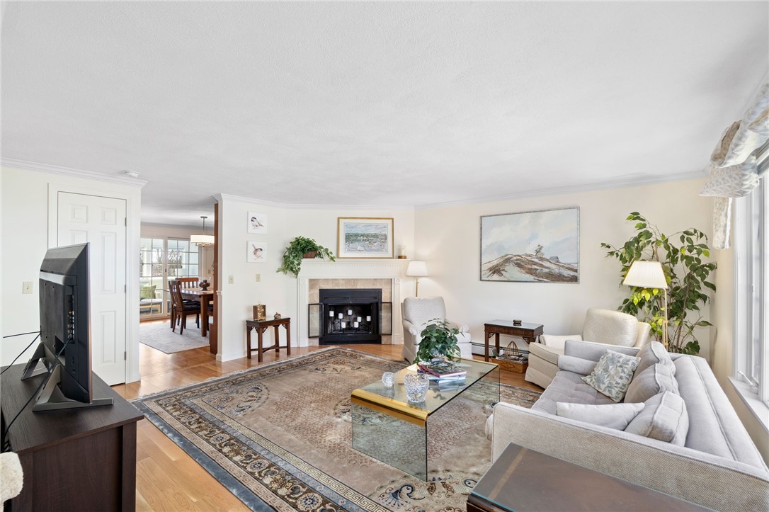 5 Eagle Run, Unit C Warwick, RI 02818 - Photo 7 of 32 Beautiful hardwood floors and crown molding make this living room an elegant space
