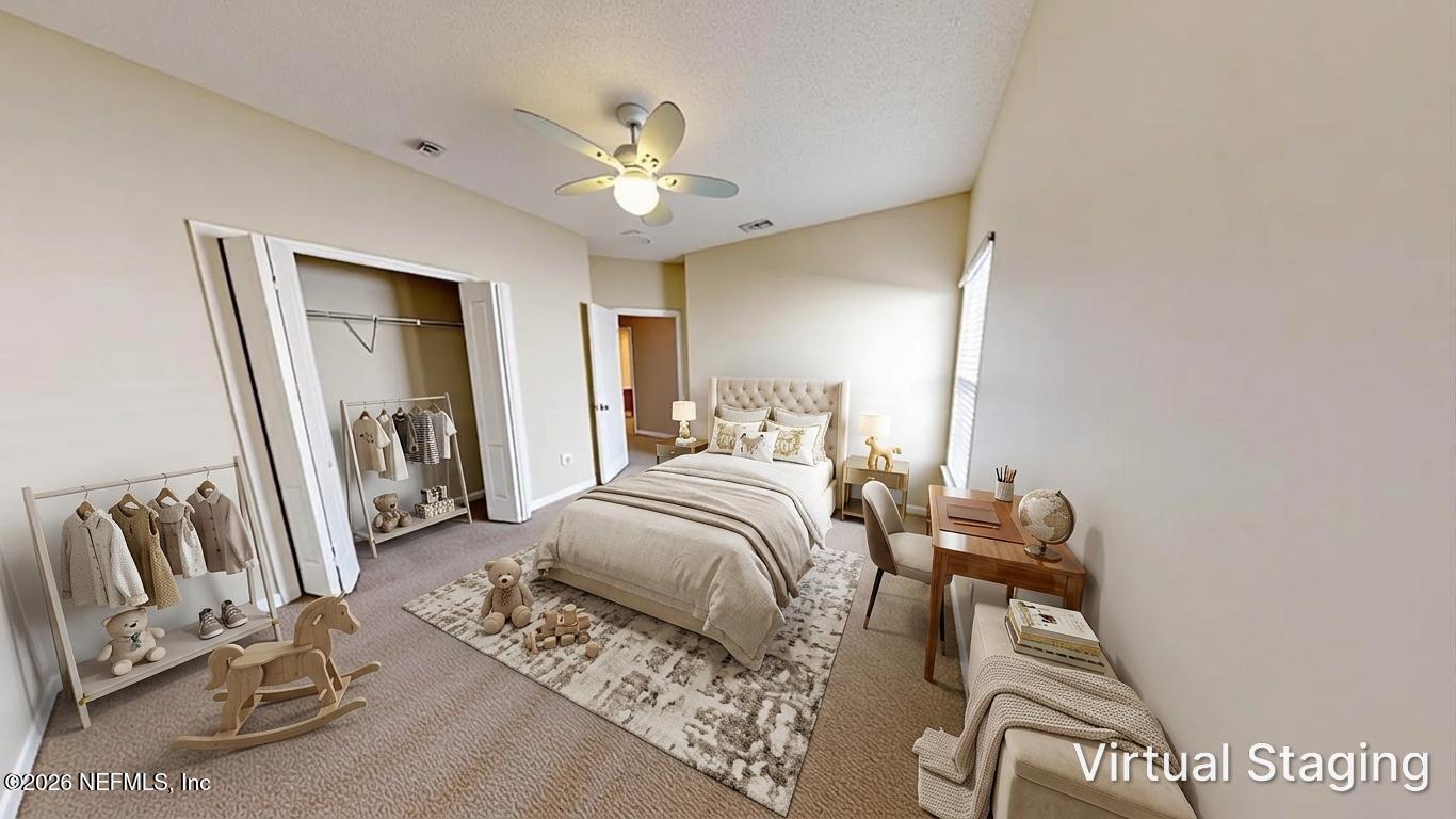 14454 Millhopper Road Jacksonville, FL 32258 - Photo 31 of 44 a bedroom with a bed and a chandelier