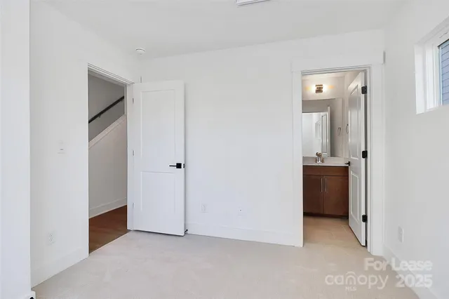 a view of an empty room with a kitchen