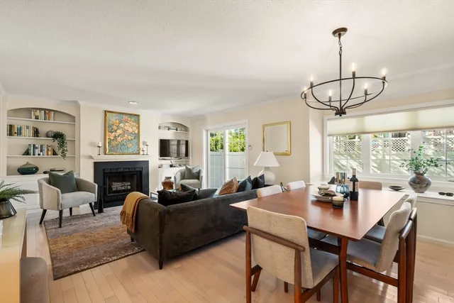 a living room with fireplace furniture and a floor to ceiling window