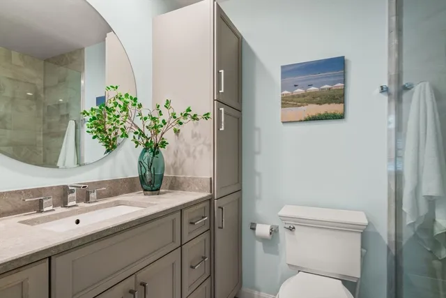 a bathroom with a toilet sink and mirror