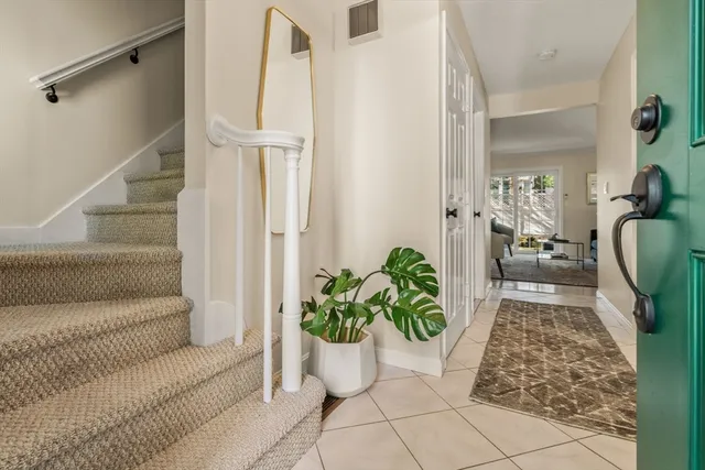 a living room with furniture and a potted plant