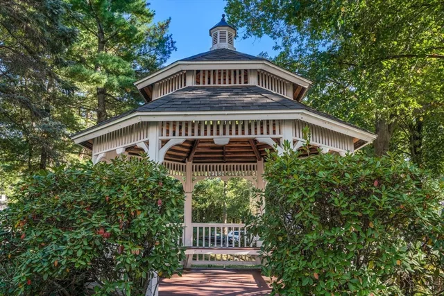 a front view of a house with plants