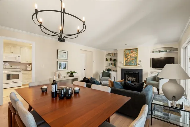 a living room with furniture a dining table and a fireplace