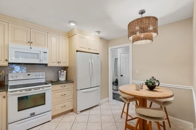 a kitchen with stainless steel appliances white cabinets and a stove