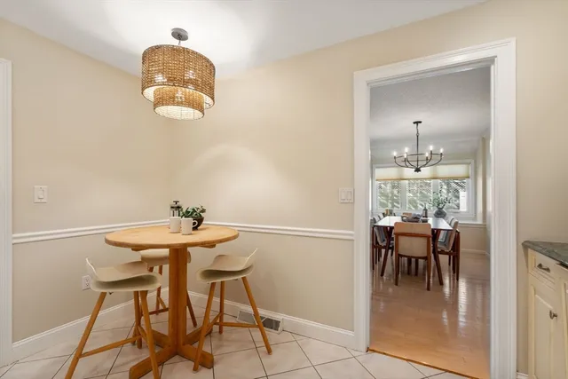 a view of a dining room with furniture and chandelier