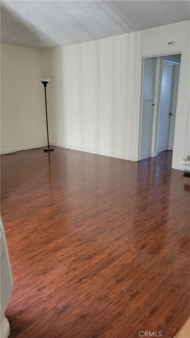 a view of a room with wooden floor and staircase