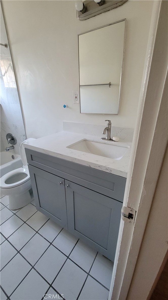 393 Waldo Avenue Pasadena, CA 91101 - Photo 3 of 3 a bathroom with a double vanity sink mirror and toilet