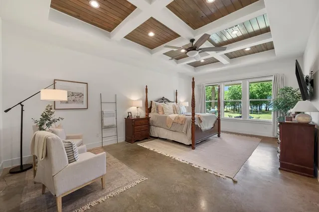 a spacious bedroom with a bed couch and a large window