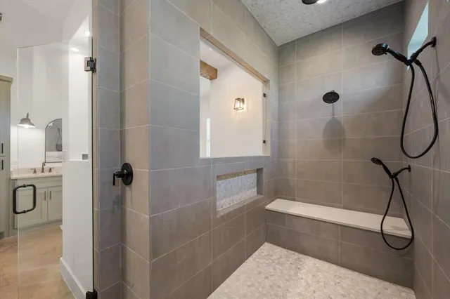 a bathroom with a tub shower and sink
