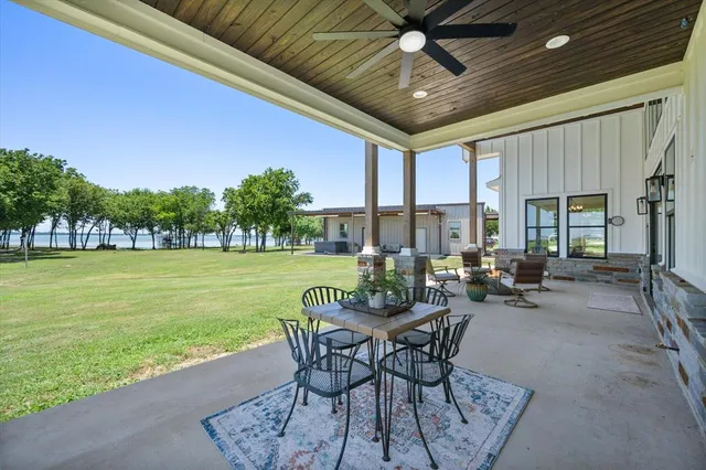 a front view of a house with swimming pool and garden