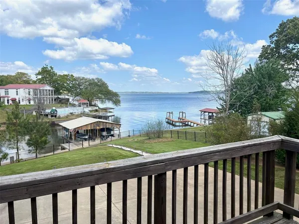 a view of a chairs and table in the balcony