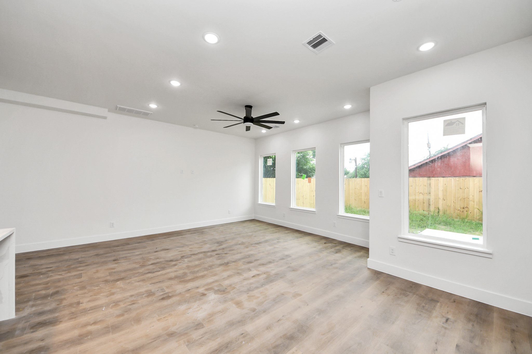 8206 Colonial Lane Houston, TX 77051 - Photo 18 of 31 an empty room with windows and ceiling fan