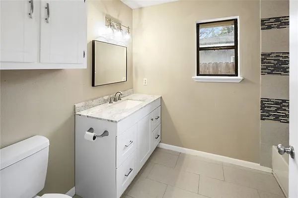 a bathroom with a double vanity sink mirror and bathtub