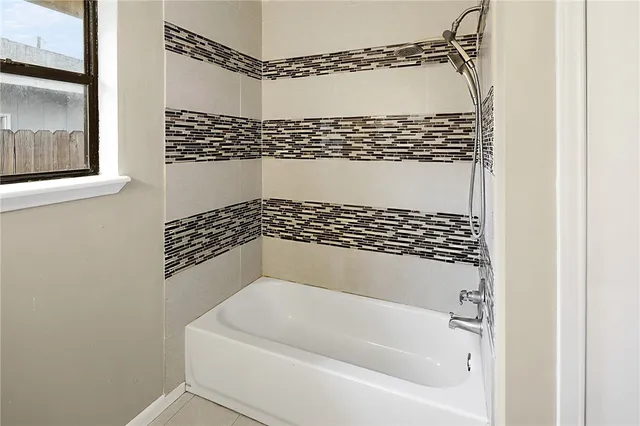 a bathroom with a bathtub and a shower