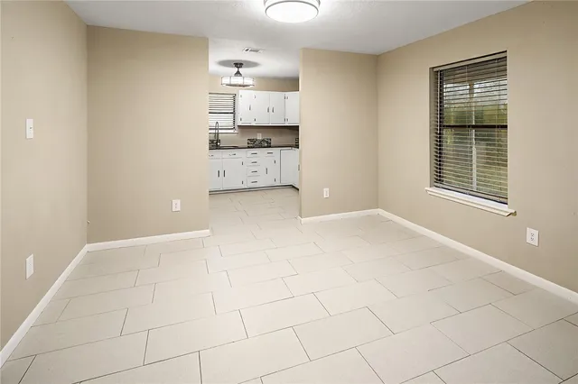 a view of kitchen with granite countertop cabinets and sink