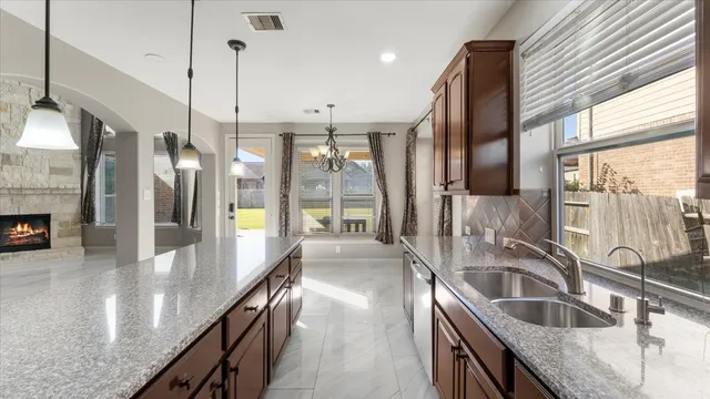 a view of a hallway with wooden floor and a chandelier fan