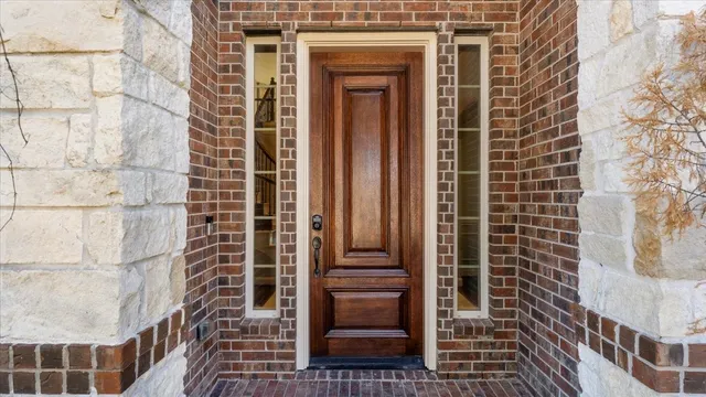a kitchen with stainless steel appliances granite countertop a sink a counter space and a refrigerator