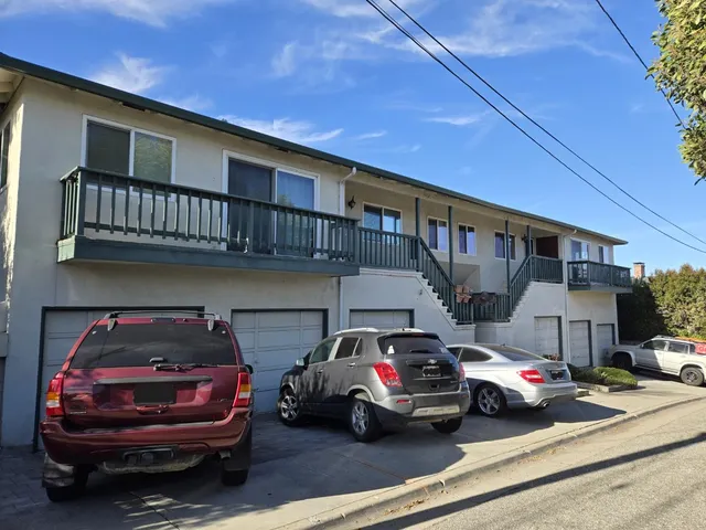 a view of a cars park in front of a building