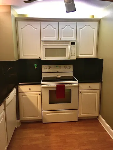 a living room with couch and a floor to ceiling window