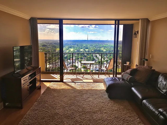 a dining room with wooden floor a glass table and chairs
